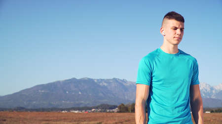 Portrait of young fit man in sports clothes with copy spaceの写真素材