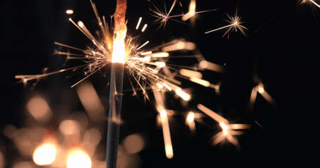 Firework sparkler burning on black background. Merry Christmas and happy new year celebrationの写真素材