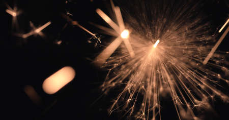 Burning firework sparks on black background, happy Christmas and New year celebrationの写真素材