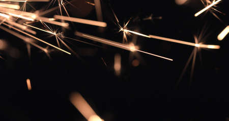 Burning firework sparks on black background, happy Christmas and New year celebrationの写真素材