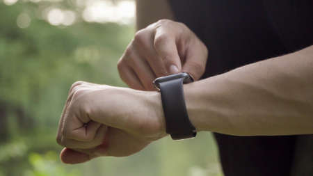 Making various gestures with a finger on a touch screen of a smart watch wearable device.