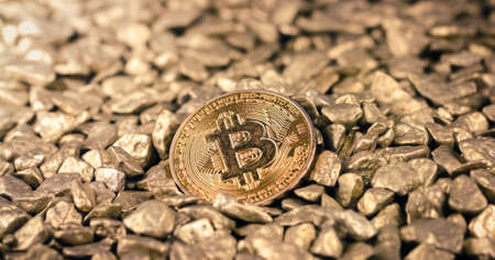 Golden Bitcoin Coin on a pile of Gold nuggets. Blockchain cryptocurrency, store of value. Digital gold concept.の写真素材