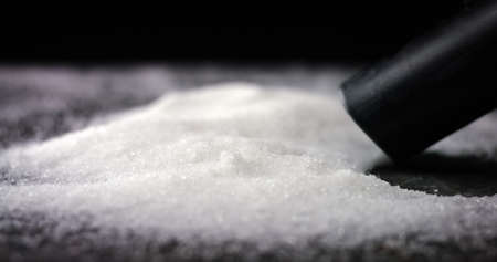 Sucking sugar or salt of a table. Deadly and toxic food. Obesity and diabetes epidemic