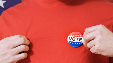 Man puting on Vote button for Presidential election 2020 in America.の写真素材