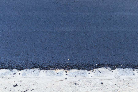Fresh black asphalt on new street road. Construction at work.の写真素材