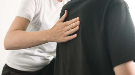 Physiotherapist exercising with disabled person on a therapy table.の写真素材