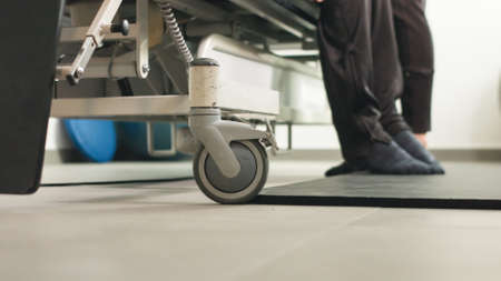 Physiotherapist exercising with disabled person on a therapy table.の写真素材