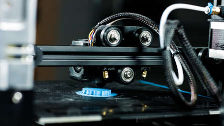 3D plastic printer during work in a factory three dimensional printing. Close-up detail.