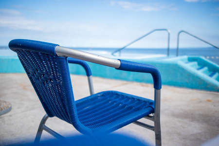 Swimming pool and blue water at the resort with beautiful sea view.の写真素材