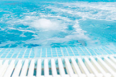 Swimming pool and blue water at the resort with beautiful sea view.