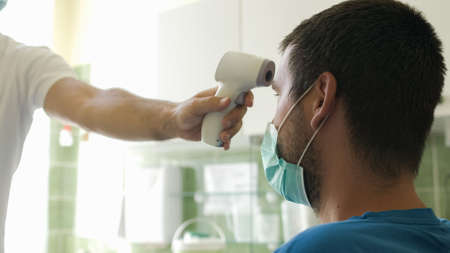 Measuring temperature for coronavirus infection with face mask.
