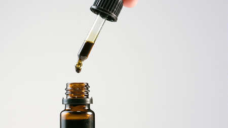 CBD Hemp oil in a bottle with pipette droplet. Cannabis extract for alternative medicine.