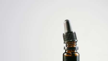 CBD Hemp oil in a bottle with pipette droplet. Cannabis extract for alternative medicine.