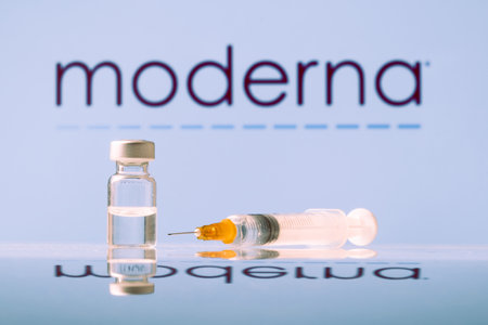 Moderna Coronavirus Vaccine vial and syringe with logo as background. LJUBLJANA, SLOVENIA: March 25, 2021のeditorial素材