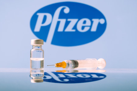Pfizer Coronavirus Vaccine vial and syringe with logo as background. LJUBLJANA, SLOVENIA: March 25, 2021のeditorial素材