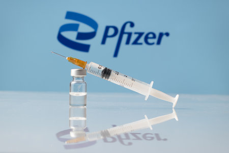 Pfizer Coronavirus Vaccine vial and syringe with logo as background. LJUBLJANA, SLOVENIA: March 25, 2021のeditorial素材