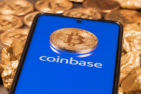 Coinbase crypto exchange logo on screen with Bitcoin coins. Ljubljana, Slovenia - April 12 2021のeditorial素材
