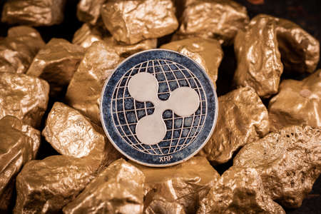 Ripple XRP cryptocurrency with gold nuggets. Investment and store of value concept.の写真素材