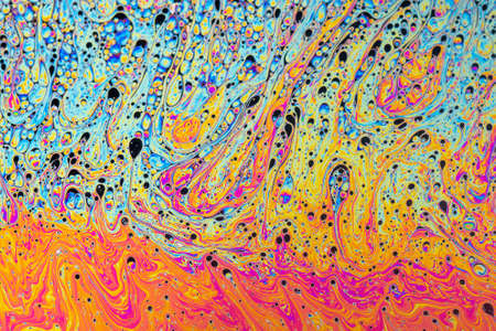 Fluid soap bubble psychedelic colorful abstract art. Surreal patterns with rainbows and waves of color in motion.の写真素材