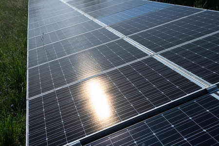 Solar panels on green meadow in nature.
