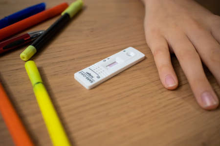 Child self testing for coronavirus at home before going to school.の写真素材