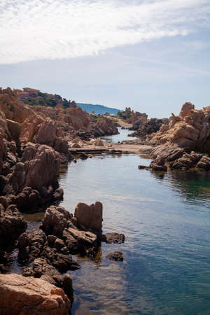 Beautiful stone coast splashed by seawater. Look on an open sea.の写真素材