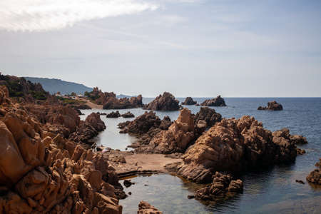 Beautiful stone coast splashed by seawater. Look on an open sea.の写真素材