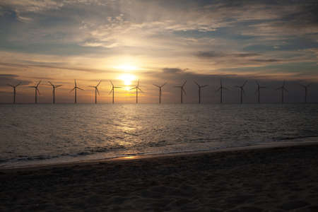 Solar panels and wind turbines generating renewable energy for green and sustainable future.の写真素材