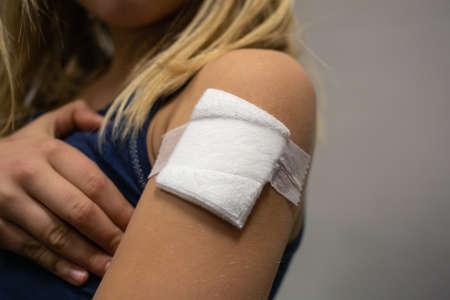 Vaccine patch on a little girl child arm.
