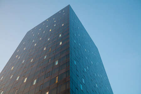 Glass skyscraper stretching into the blue skyの写真素材