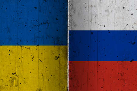 Ukraine and Russia national flags on a grunge texture symbolising war and conflict.