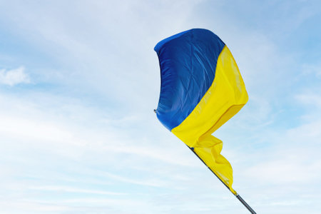 Ukraine national flag waving in wind against sky. Blue and yellow color.の写真素材