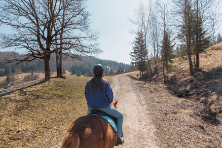 Young woman riding Icelandic horse in nature at spring.の写真素材
