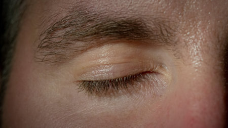 Closed human eye of a male close-up shot. Waking time and life-changing moment concepts.の写真素材