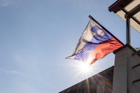 Slovenia national flag waving in the wind with sun shiningの写真素材
