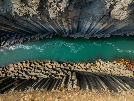Canyon of magnificent basalt columns, high cliff with bright turquoise river, in North East Iceland, aerial shot. Studlagil, nature beauty concept.の写真素材