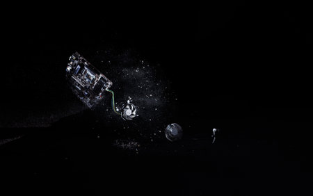 Hard hit of a motherboard on the floor, scattered parts on a black background, isolated, slow motion locked down shot. Electronic waste and new technology concepts.の写真素材
