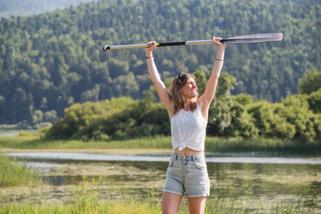 Young woman on a summer lake vacation, going on a canoe ride.の写真素材