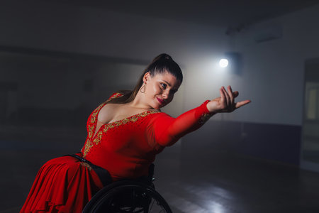 Beautiful dance in a wheelchair of a woman with disability at a dancing studio. Para dance sport.の写真素材