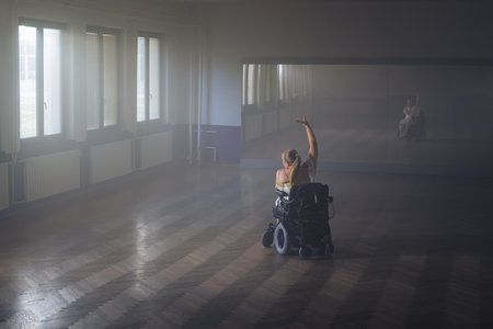 Graceful and elegant movements of a woman with a disability during a solo dance choreography performance on a wheelchairの写真素材