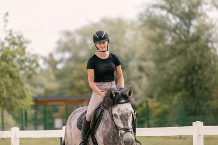 Young woman and her beautiful red horse during calm trail ride. Ecotourism and animal care concepts.