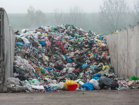 Landfill site, a pile of different junk disposal in the concrete section for unsorted waste...