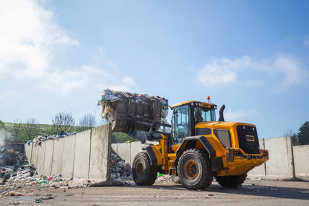Front loader with scrap handling grapple bucket moving forward and backward to push, scoop and dump...