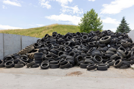 Heap of old used industrial rubber tires specially selected from the garbage in a recycling plant for separate recyclingの写真素材