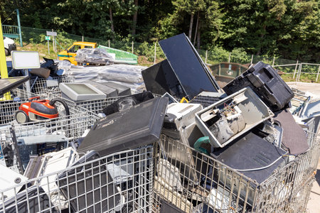 Electrical and electronic waste disposed of in a recycling center, close up shot. E-waste, repair,...