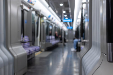 Blurred empty interior of a modern metro train, inside of an underground subway train with two unrecognizable people. Public transportation concept.の写真素材