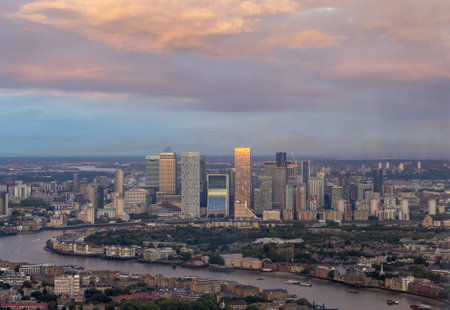 Panoramic view of London city skyline illuminated by colorful sunset light, aerial shot. Famous landmark buildings and architectural attractions on the river banks.の写真素材