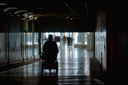 Person driving electric wheelchair in a hallwayの写真素材