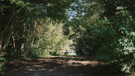 Whitewater kayaker paddling on the waters of river. Adrenaline seekers and nature lovers.の写真素材
