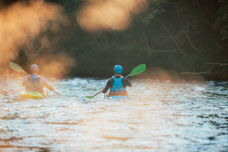 Two whitewater kayakers paddling on the waters of river. Adrenaline seekers and nature lovers.の写真素材